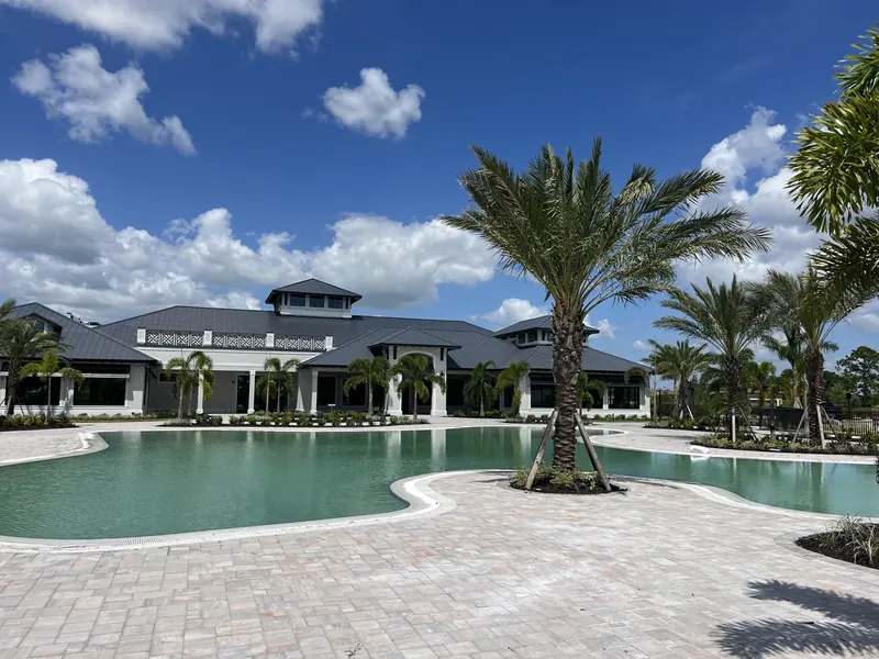 Finished commercial resort pool filled with water, decking and landscaping complete